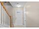 Bright entryway featuring tiled floors, stairs with wooden handrail, and white front door with glass panel at 2131 Cass Lake Dr. # 662, Carolina Shores, NC 28467
