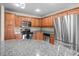 The kitchen features stainless steel appliances, granite countertops, and natural wood cabinets at 2131 Cass Lake Dr. # 662, Carolina Shores, NC 28467