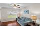 Cozy living room with hardwood floors, a comfortable blue sofa, and a window offering natural light at 2131 Cass Lake Dr. # 662, Carolina Shores, NC 28467