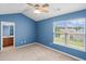 Bright main bedroom with vaulted ceiling, a ceiling fan, large window, and ensuite bath at 2131 Cass Lake Dr. # 662, Carolina Shores, NC 28467