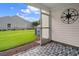 View of outdoor screened patio with decorative blue flooring and a well-maintained green lawn at 2131 Cass Lake Dr. # 662, Carolina Shores, NC 28467