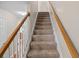 Carpeted stairway features wooden railing and bright lighting at 2131 Cass Lake Dr. # 662, Carolina Shores, NC 28467
