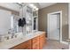 Bathroom with double sinks, a marble countertop, and a large walk-in shower with modern fixtures at 232 White Water Loop, Conway, SC 29526