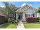 Charming home entrance with a palm tree, colorful bushes and a walkway leading to a black front door at 232 White Water Loop, Conway, SC 29526