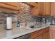 Kitchen sink with tile backsplash and countertop appliances at 232 White Water Loop, Conway, SC 29526