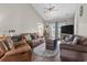 Comfortable living room with leather furniture, a ceiling fan, and a large television for entertainment at 232 White Water Loop, Conway, SC 29526
