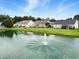 Waterfront houses overlooking a pond with a fountain in a quiet residential community at 232 White Water Loop, Conway, SC 29526