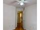 Bedroom featuring neutral walls, wood floor, with view into bathroom and ceiling fan at 233 Melody Gardens Dr., Surfside Beach, SC 29575
