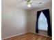 Modest bedroom featuring light-toned walls, wood floor, window, and ceiling fan at 233 Melody Gardens Dr., Surfside Beach, SC 29575