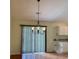 Dining area with chandelier, vertical blinds, and view of sliding glass doors to the exterior at 233 Melody Gardens Dr., Surfside Beach, SC 29575