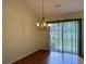 Bright dining area featuring hardwood floors and sliding glass doors to the outside at 233 Melody Gardens Dr., Surfside Beach, SC 29575