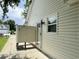 Exterior of home features vinyl siding, patio area, and glass door at 233 Melody Gardens Dr., Surfside Beach, SC 29575