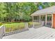 Inviting back deck and screened-in porch overlooking lush greenery, perfect for outdoor relaxation and entertaining at 241 Black Duck Rd., Pawleys Island, SC 29585