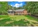 Expansive backyard with lush lawn, screened porch, and deck—ideal for outdoor enjoyment and gatherings at 241 Black Duck Rd., Pawleys Island, SC 29585