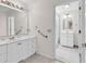 Bathroom features double sinks and white cabinets, with an open doorway to another bathroom at 241 Black Duck Rd., Pawleys Island, SC 29585