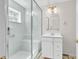 Modern bathroom with glass shower and bench seating, featuring a sink with vanity and bright lighting at 241 Black Duck Rd., Pawleys Island, SC 29585
