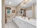 Bathroom with a large mirror, ample counter space, and floral window coverings at 241 Black Duck Rd., Pawleys Island, SC 29585
