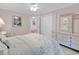 Comfortable bedroom with floral bedding and a four-poster bed and a view of the closet at 241 Black Duck Rd., Pawleys Island, SC 29585