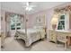 Charming bedroom featuring a four-poster bed, a ceiling fan, and large windows with natural light at 241 Black Duck Rd., Pawleys Island, SC 29585