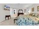 Comfortable bedroom with floral bedding, a ceiling fan, and a TV on the wall at 241 Black Duck Rd., Pawleys Island, SC 29585