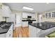 Well-lit kitchen features granite countertops, white cabinetry, and stainless steel appliances at 241 Black Duck Rd., Pawleys Island, SC 29585
