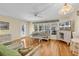 Bright living room with hardwood floors, wicker furniture, and floral accents at 241 Black Duck Rd., Pawleys Island, SC 29585