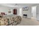 Bright main bedroom featuring a floral bedspread, TV, and walk-in closet access at 241 Black Duck Rd., Pawleys Island, SC 29585