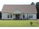 Spacious backyard featuring a covered patio and outdoor seating, perfect for entertaining and relaxation at 242 Four Mile Rd., Conway, SC 29526