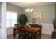 Charming dining room with wood table, six chairs, chandelier, and wainscoting at 242 Four Mile Rd., Conway, SC 29526