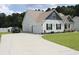 Well-maintained home featuring a spacious driveway, attached garage, and lush green lawn at 242 Four Mile Rd., Conway, SC 29526