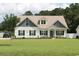 Charming two-story home with a well-manicured lawn and inviting curb appeal, enhanced by mature trees at 242 Four Mile Rd., Conway, SC 29526