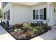 Eye-catching flowerbed features a bench, showcasing the home's meticulous landscaping and curb appeal at 242 Four Mile Rd., Conway, SC 29526