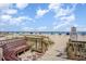 Convenient beach access featuring a wooden walkway with benches and ocean views at 2501 S Ocean Blvd. # 503, Myrtle Beach, SC 29577
