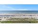 Expansive beach view showing sandy shores and vibrant beach umbrellas under a clear blue sky at 2501 S Ocean Blvd. # 503, Myrtle Beach, SC 29577