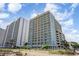 Exterior shot of the condo buildings with beach access and blue skies on a beautiful day at 2501 S Ocean Blvd. # 503, Myrtle Beach, SC 29577