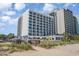 Exterior view from the beach highlighting the building's beachfront location and coastal charm at 2501 S Ocean Blvd. # 503, Myrtle Beach, SC 29577