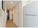 A view of a hallway with tile flooring and white appliances, along with bi-fold closet doors at 2501 S Ocean Blvd. # 503, Myrtle Beach, SC 29577