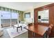 Bright living room with a balcony overlooking the ocean, and a dining table reflected in a cabinet at 2501 S Ocean Blvd. # 503, Myrtle Beach, SC 29577