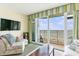 Inviting living room with ocean view, balcony, TV, and comfortable seating at 2501 S Ocean Blvd. # 503, Myrtle Beach, SC 29577