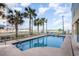 Outdoor pool area with palm trees, lounge chairs and partial ocean view at 2501 S Ocean Blvd. # 503, Myrtle Beach, SC 29577