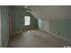 A carpeted attic space with a window and a small door at 274 Widgeon Dr., Pawleys Island, SC 29585