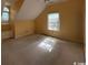 A carpeted attic room with a built-in cabinet and natural light at 274 Widgeon Dr., Pawleys Island, SC 29585