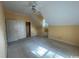 A carpeted attic room with a ceiling fan and built-in cabinets at 274 Widgeon Dr., Pawleys Island, SC 29585