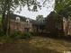 Rear exterior view of a brick home with dormer windows and a multi-car garage at 274 Widgeon Dr., Pawleys Island, SC 29585