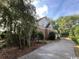 Brick home with a long driveway and mature landscaping on a sunny day at 274 Widgeon Dr., Pawleys Island, SC 29585