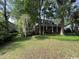 Traditional home surrounded by mature trees and lush greenery creating a private setting at 274 Widgeon Dr., Pawleys Island, SC 29585