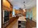 Spacious kitchen with wooden cabinets, granite counters, an island, and stainless-steel appliances at 274 Widgeon Dr., Pawleys Island, SC 29585