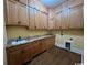 Functional laundry room featuring wooden cabinets, granite counters, and a sink at 274 Widgeon Dr., Pawleys Island, SC 29585