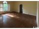 Bright living room with hardwood floors, an archway, and large windows at 274 Widgeon Dr., Pawleys Island, SC 29585