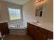 Bathroom featuring garden tub, neutral countertop vanity and large window at 298 Weyburn St., Myrtle Beach, SC 29579